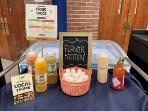 Photo: Table set up with different sauces to add to a student meal, featuring local Craic Sauce